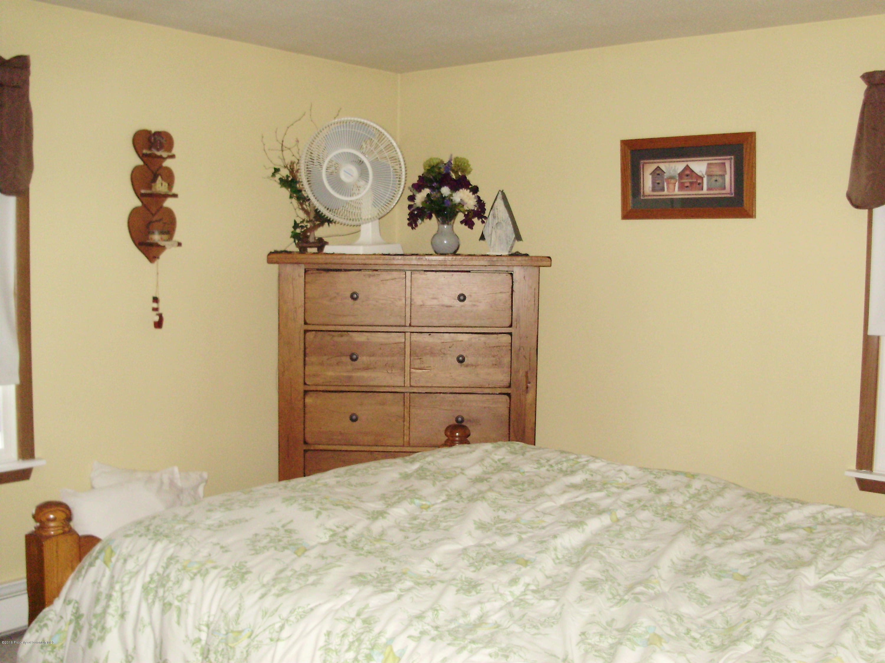 906 Johnson Road Hallstead, PA 18822 - Photo 30 of 31 a bed room with a bed and a table