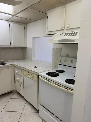 a kitchen with cabinets and appliances
