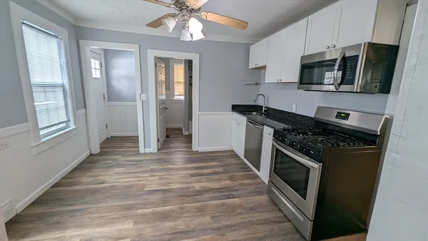 a kitchen with stainless steel appliances a stove microwave and cabinets