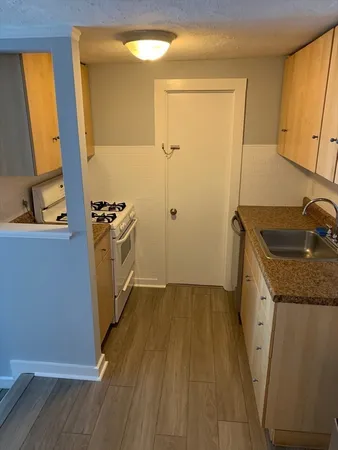 a kitchen with sink and refrigerator
