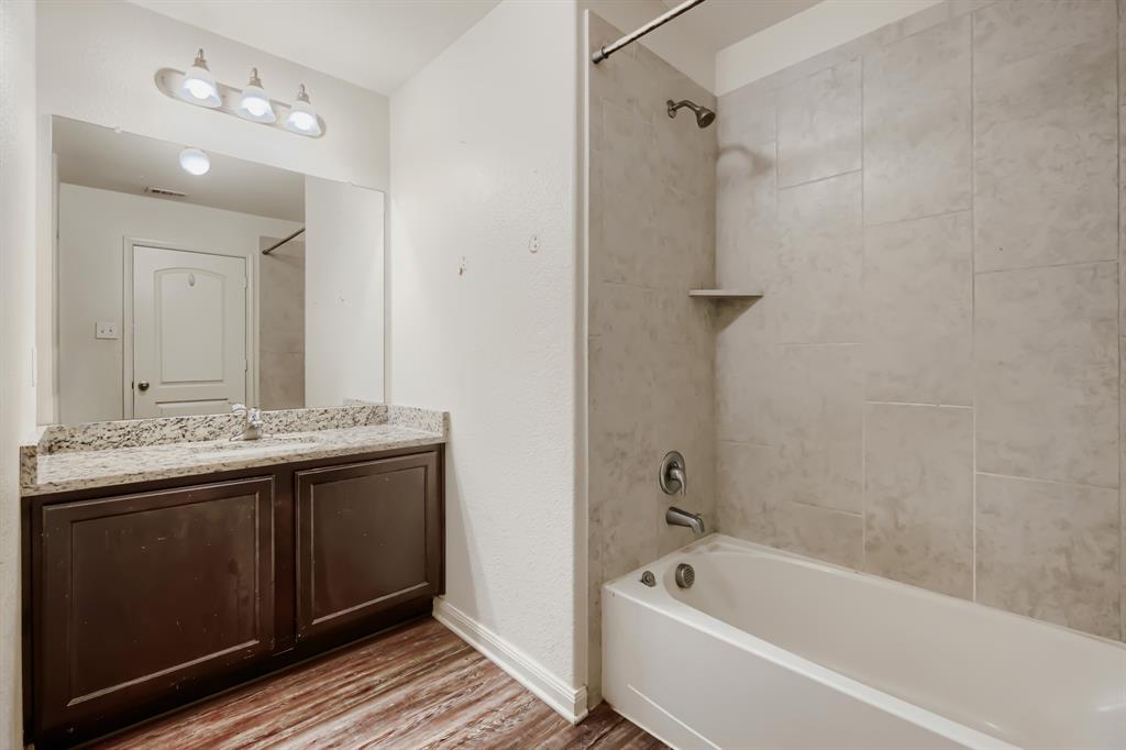 4309 Cat Tail Way Forney, TX 75126 - Photo 26 of 30 Second Bathroom featuring a dark wood-finish vanity with a light-toned countertop, a rectangular mirror, and a three-light fixture