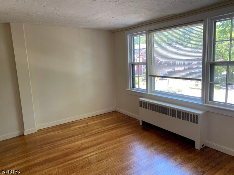 13 Bridge Street Stockton, NJ 08559 - Photo 3 of 11 a view of an empty room with wooden floor and a window