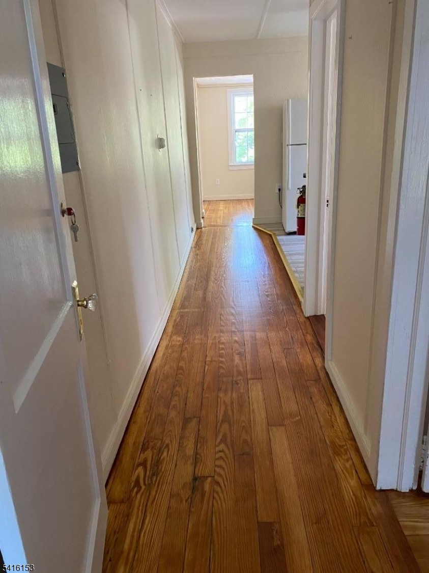 13 Bridge Street Stockton, NJ 08559 - Photo 4 of 11 a view of a hallway with wooden floor and staircase