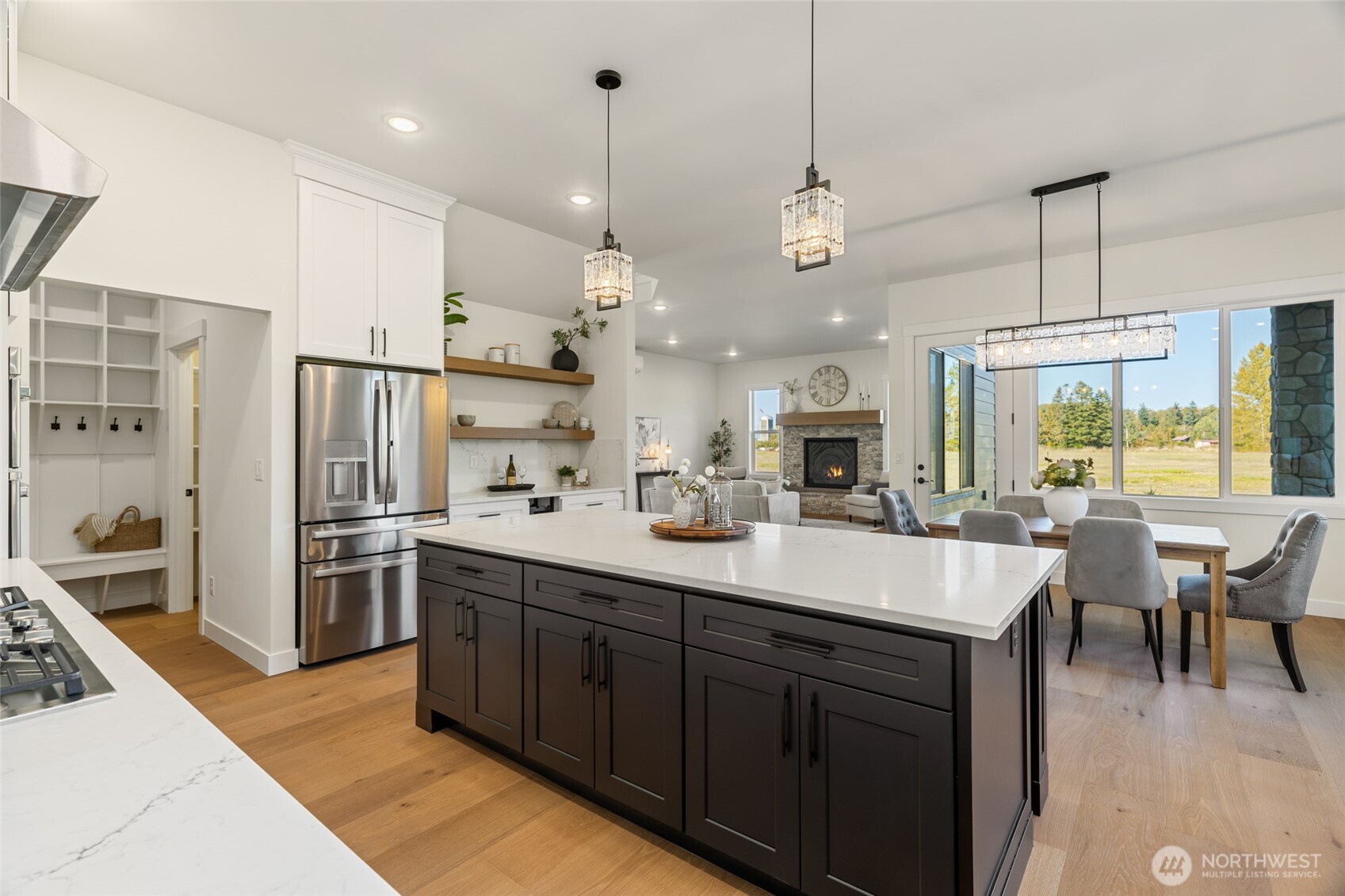 1354 Huntley Road Bellingham, WA 98226 - Photo 14 of 40 a large kitchen with kitchen island a large island in the center a sink stainless steel appliances and cabinets