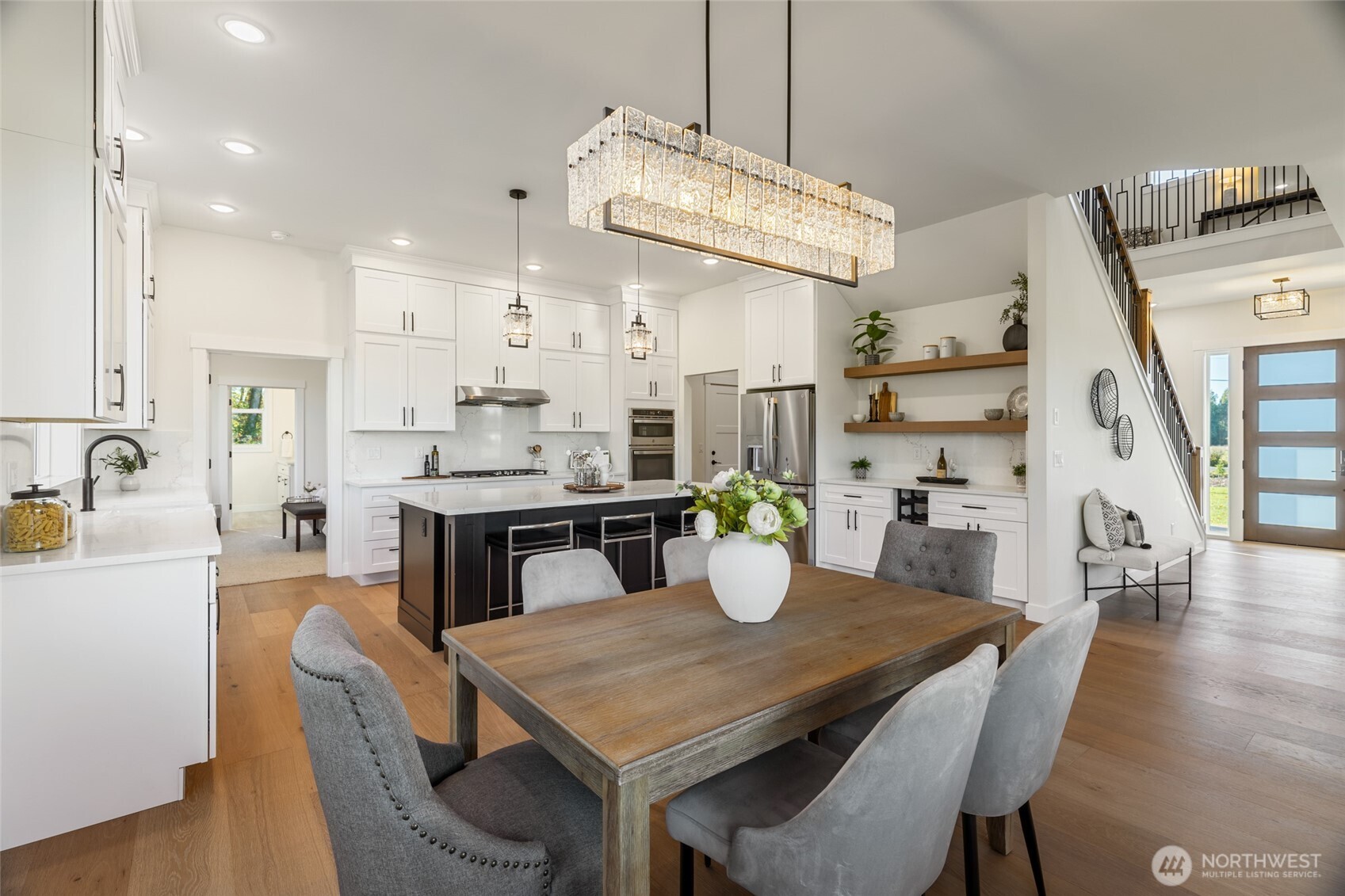1354 Huntley Road Bellingham, WA 98226 - Photo 16 of 40 a dining room with stainless steel appliances kitchen island a table chairs and a kitchen view