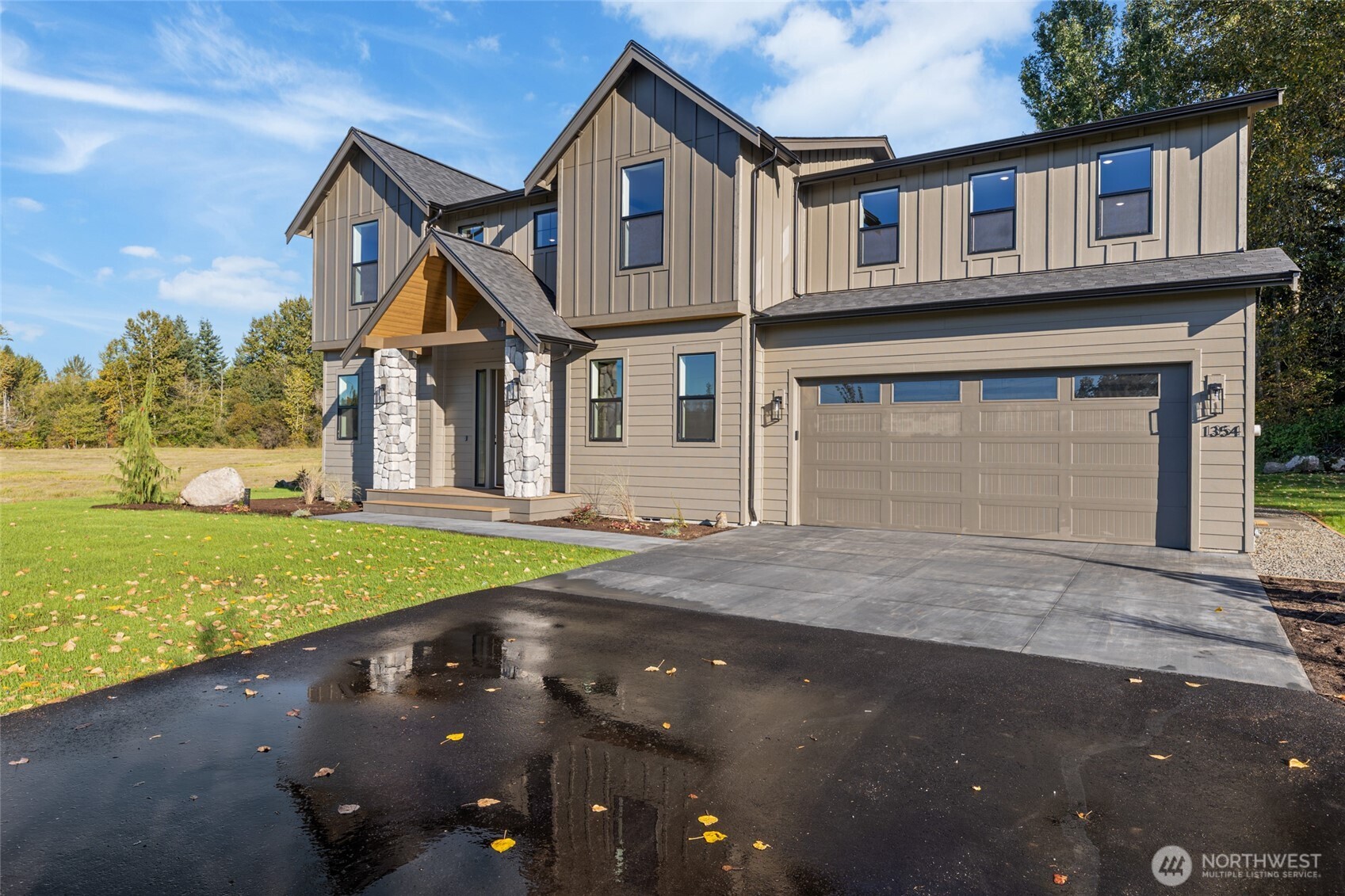 1354 Huntley Road Bellingham, WA 98226 - Photo 2 of 40 a front view of a house with a yard and garage