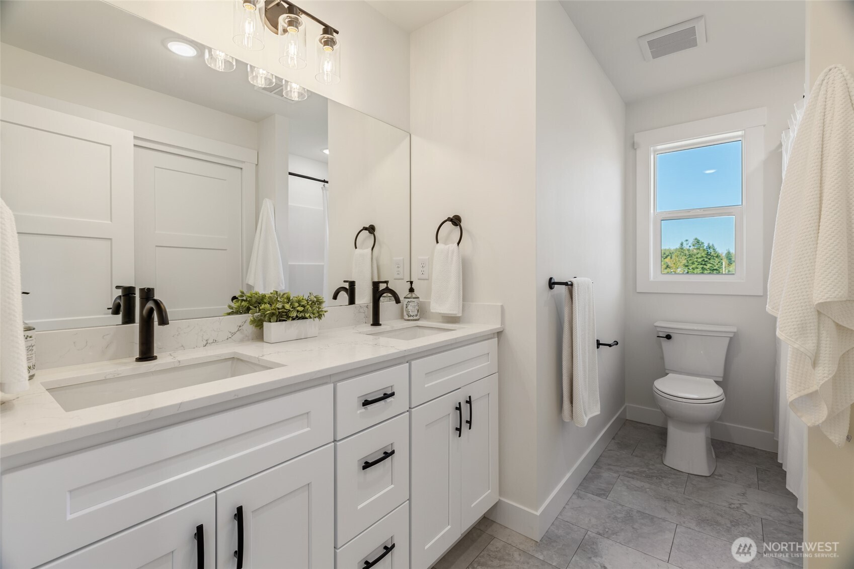 1354 Huntley Road Bellingham, WA 98226 - Photo 30 of 40 a bathroom with a sink a toilet and a mirror