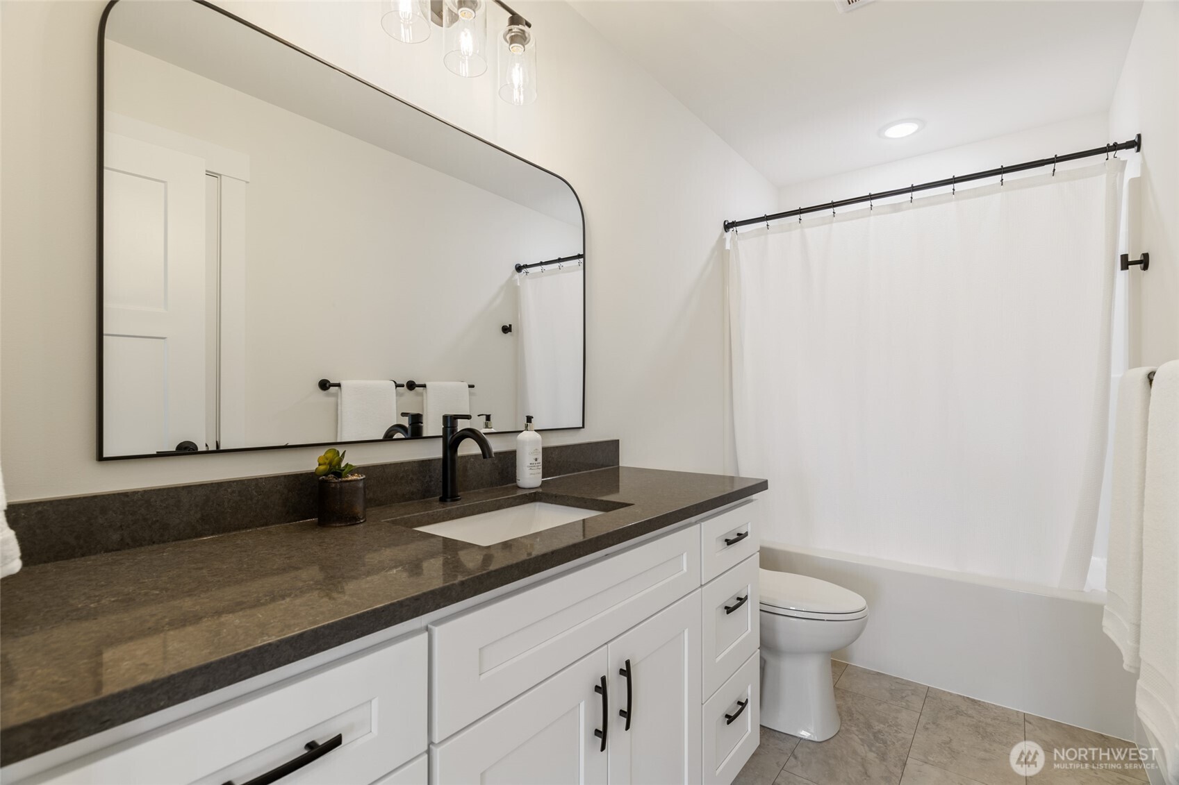 1354 Huntley Road Bellingham, WA 98226 - Photo 34 of 40 a bathroom with a granite countertop sink a toilet and a mirror