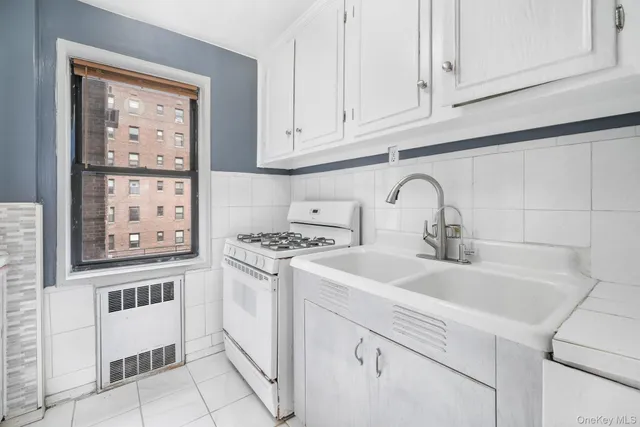 a kitchen with stainless steel appliances granite countertop a sink and a stove top oven