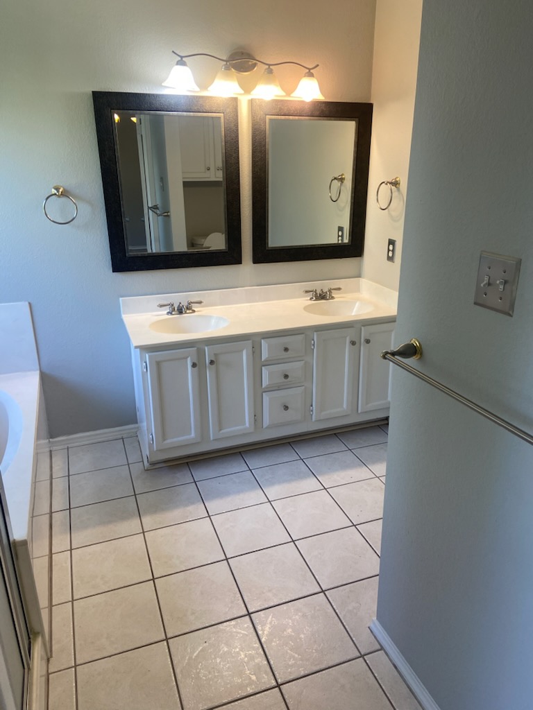 17616 Tobermory Drive Pflugerville, TX 78660 - Photo 6 of 14 Double vanities with ample counter space anchor this practical bathroom.