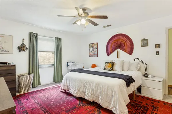 a bed room with a bed and a chair