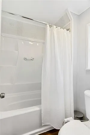 a bathroom with a shower curtain and a curtain