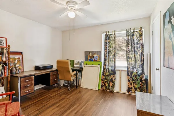 a view of a workspace with furniture and wooden floor