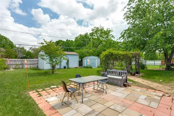 a view of a chair and table in the garden