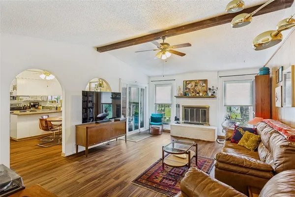 a living room with fireplace furniture and a wooden floor