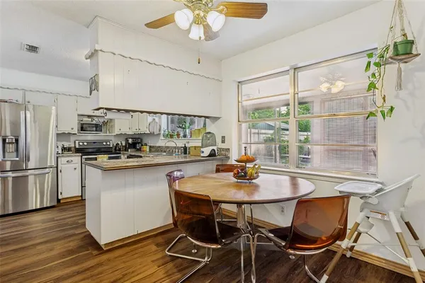 a kitchen with a table and chairs in it