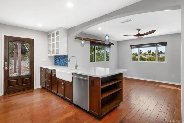 a kitchen with stainless steel appliances granite countertop a stove a sink and a refrigerator