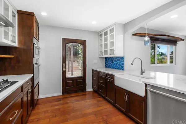 a kitchen with stainless steel appliances kitchen island granite countertop a sink stove and cabinets