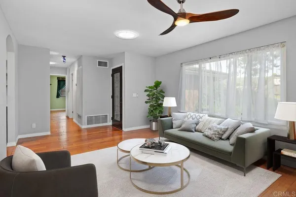 a view of empty room with wooden floor and fireplace
