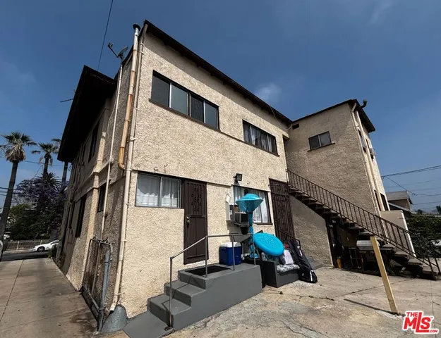 a kitchen with stainless steel appliances a white refrigerator a stove a sink and dishwasher with white cabinets