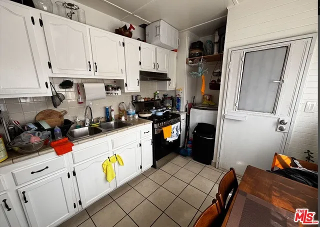 a utility room with wooden floor washer and dryer