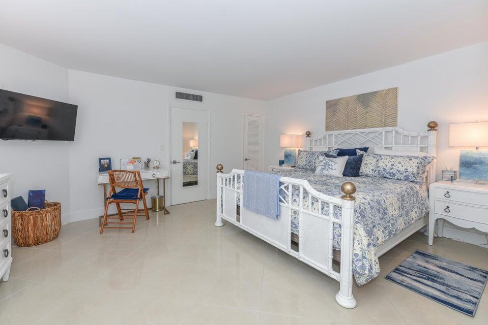 2860 South Ocean Boulevard, Unit 202 Palm Beach, FL 33480 - Photo 13 of 33 a bedroom with furniture and a flat screen tv