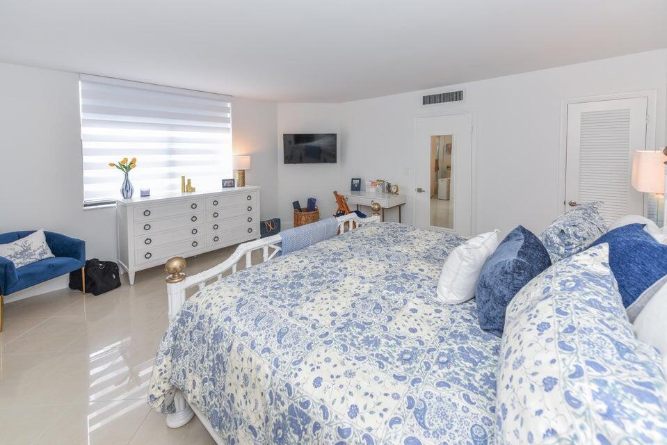 2860 South Ocean Boulevard, Unit 202 Palm Beach, FL 33480 - Photo 14 of 33 a bedroom with a bed and a flat tv screen on dresser