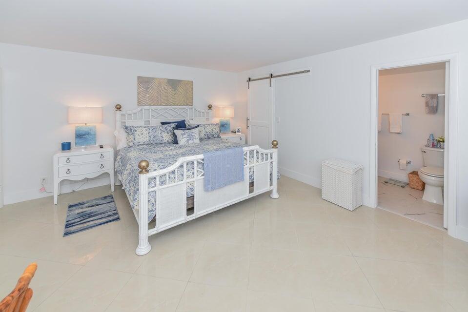 2860 South Ocean Boulevard, Unit 202 Palm Beach, FL 33480 - Photo 15 of 33 a spacious bedroom with a bed and a cabinets