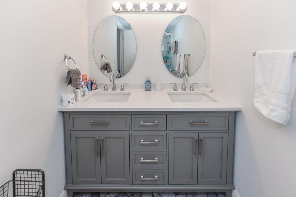 2860 South Ocean Boulevard, Unit 202 Palm Beach, FL 33480 - Photo 17 of 33 a bathroom with a double vanity sink and a mirror