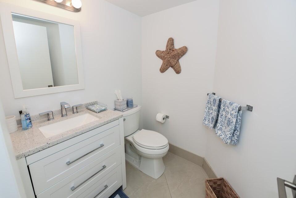 2860 South Ocean Boulevard, Unit 202 Palm Beach, FL 33480 - Photo 20 of 33 a bathroom with a granite countertop toilet sink and mirror