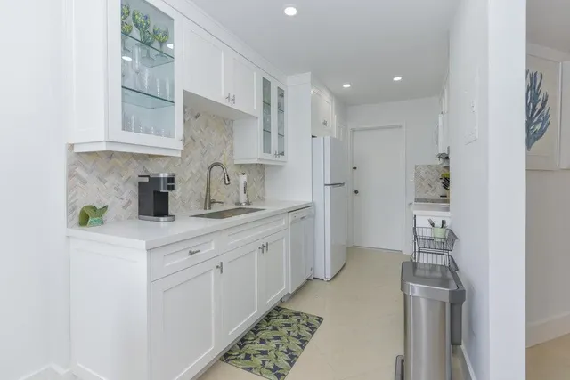 a kitchen with cabinets and window