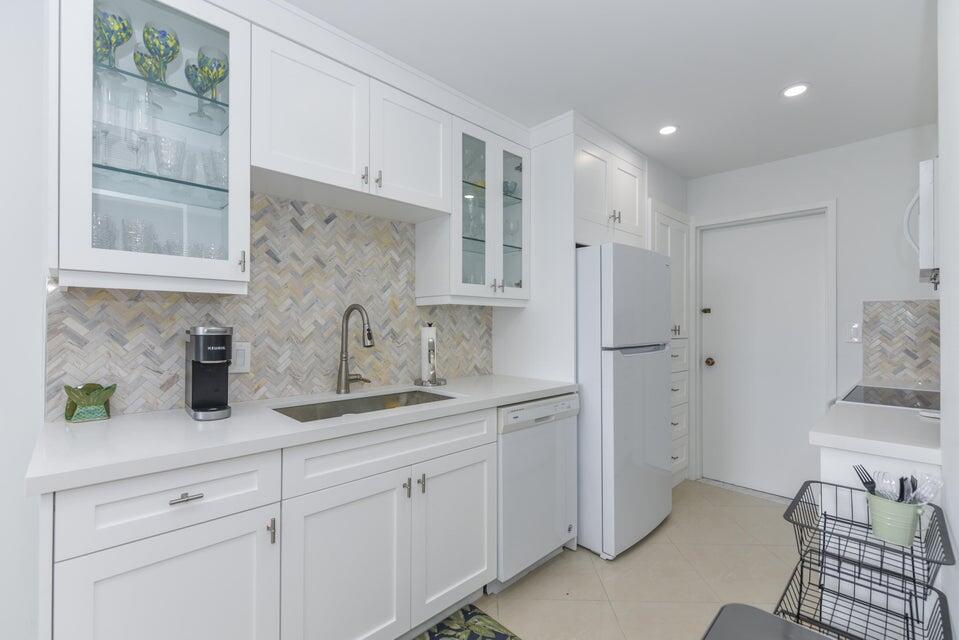 2860 South Ocean Boulevard, Unit 202 Palm Beach, FL 33480 - Photo 10 of 33 a kitchen with cabinets and window