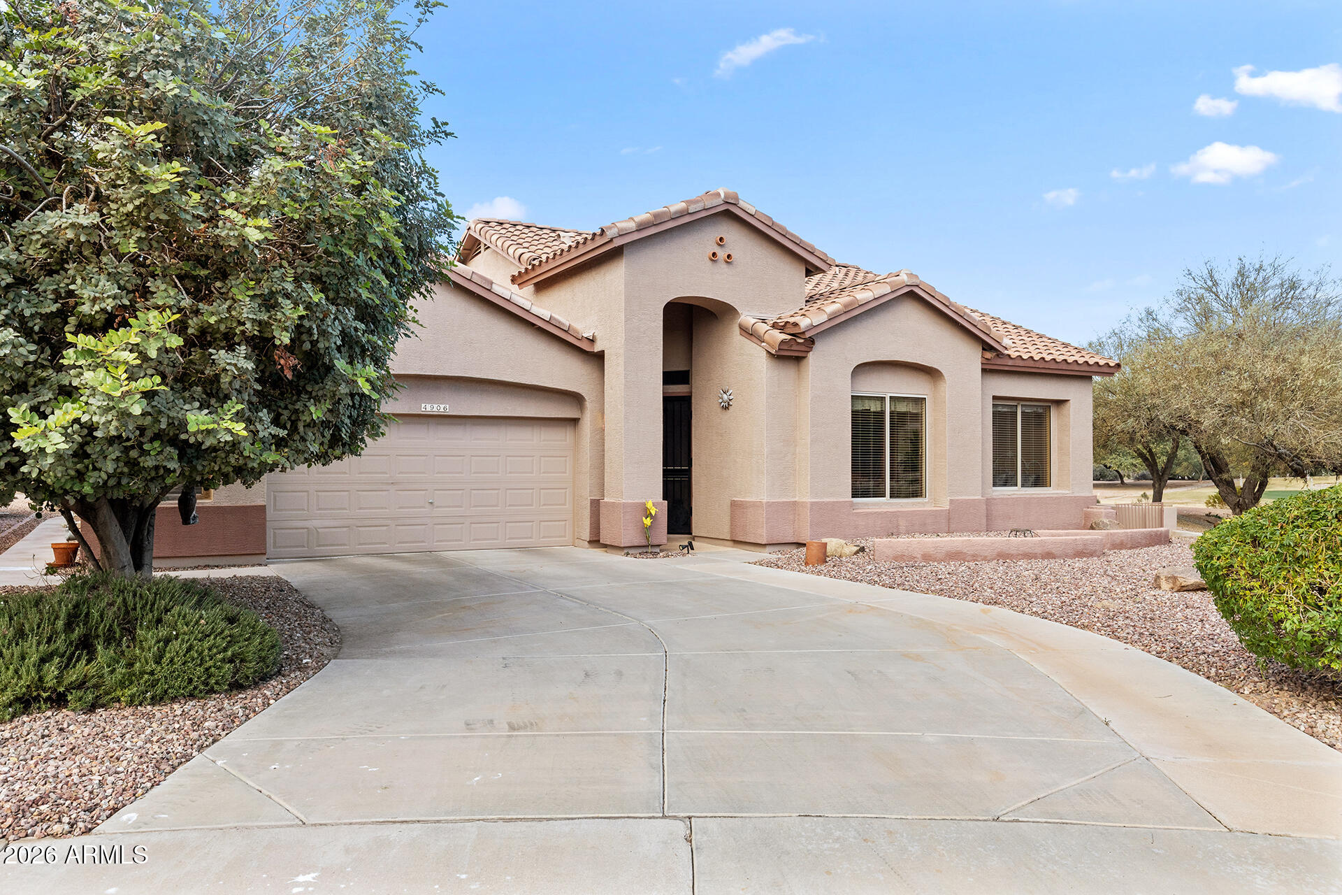 4906 South Verbena Avenue Gilbert, AZ 85298 - Photo 2 of 46 a view of a house with a yard and garage