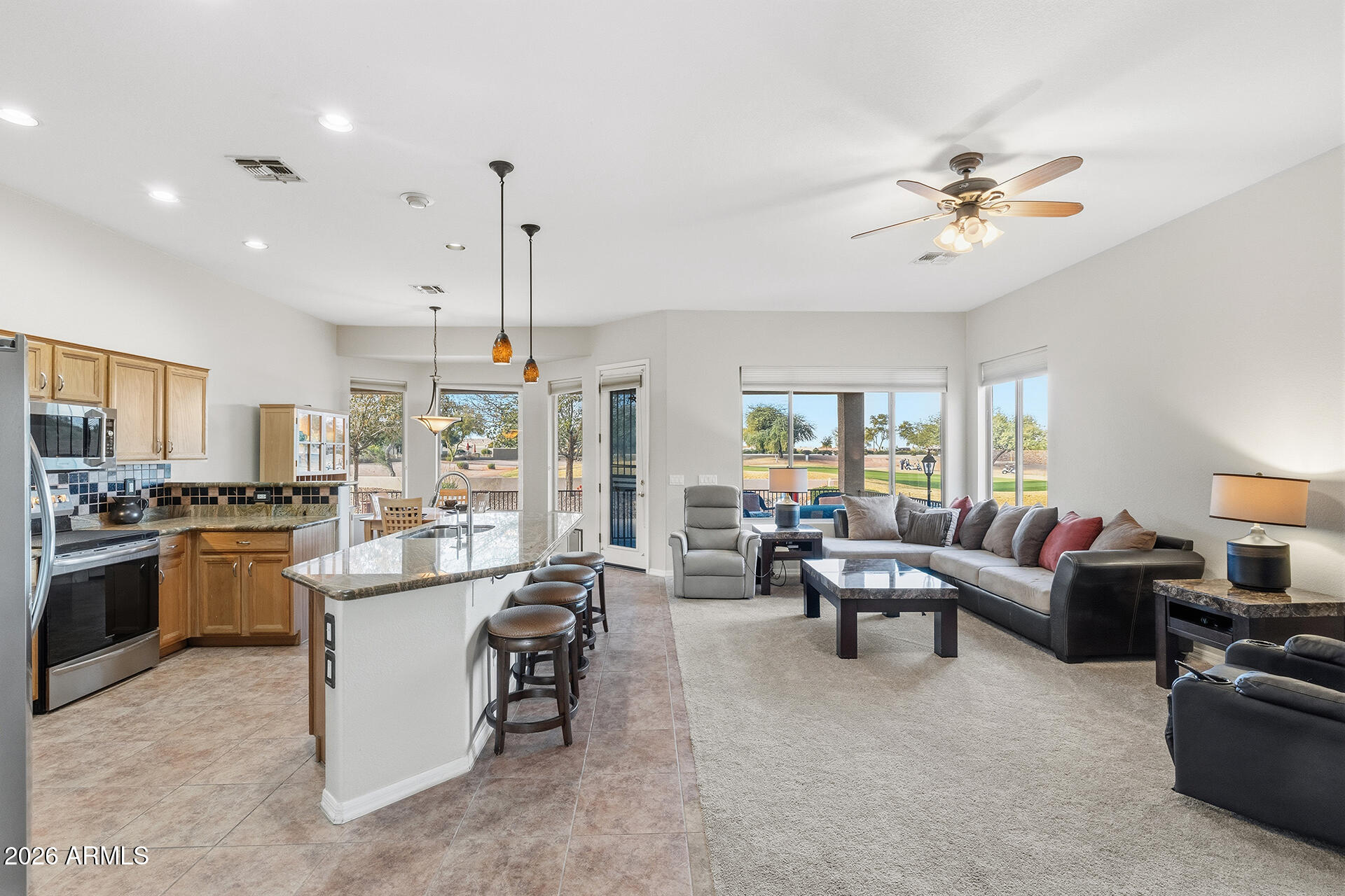 4906 South Verbena Avenue Gilbert, AZ 85298 - Photo 5 of 46 a living room with kitchen island furniture and a chandelier