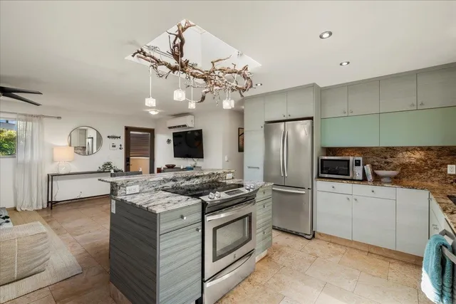 a kitchen with a stove a refrigerator and a microwave