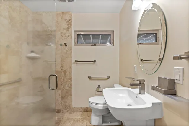 a bathroom with a toilet sink and mirror