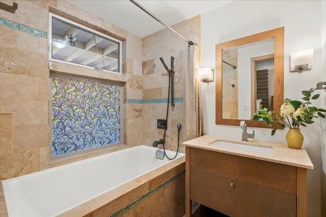 a bedroom with a bed table flowerpot and window