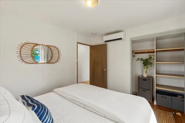 a bedroom with a bed and a potted plant