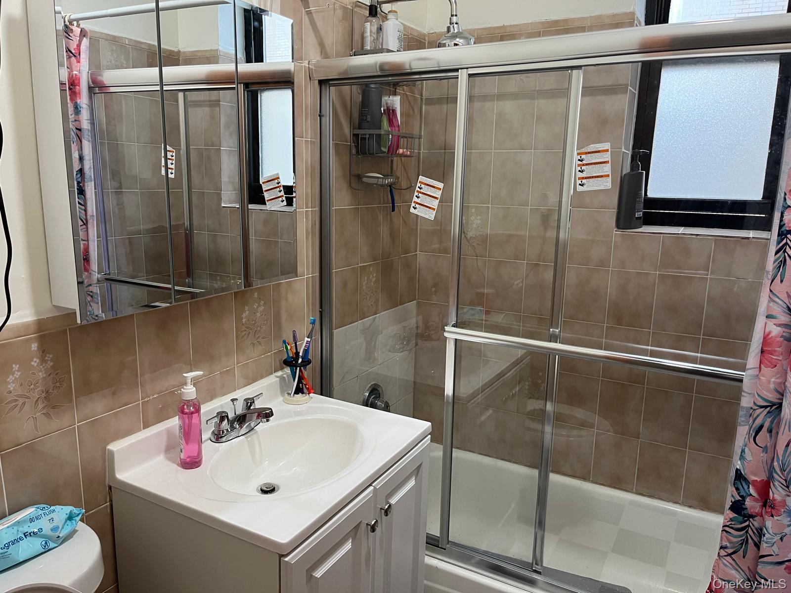 40-36 100th Street Queens, NY 11368 - Photo 5 of 11 a bathroom with a sink and mirror