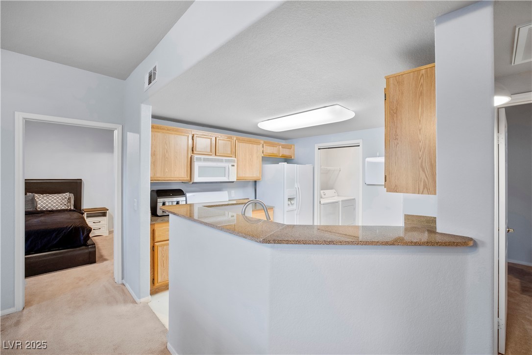 10001 Peace Way, Unit 1264 Las Vegas, NV 89147 - Photo 8 of 27 Kitchen showing laundry and bedroom
