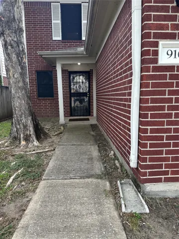 a view of a brick house with many windows