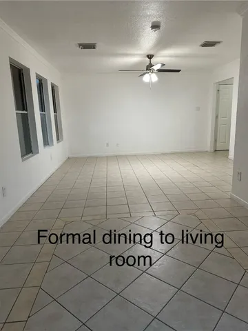 a view of a kitchen with kitchen island a sink wooden floor and a counter top space