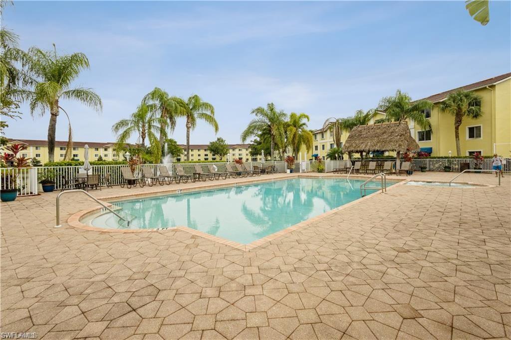 8234 Key Royal Circle, Unit 521 Naples, FL 34119 - Photo 15 of 19 a view of swimming pool with outdoor seating