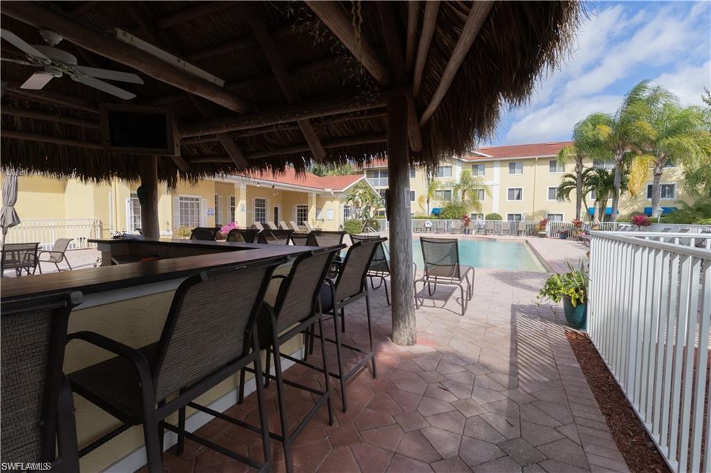 8234 Key Royal Circle, Unit 521 Naples, FL 34119 - Photo 16 of 19 a view of an outdoor space with a table and chairs