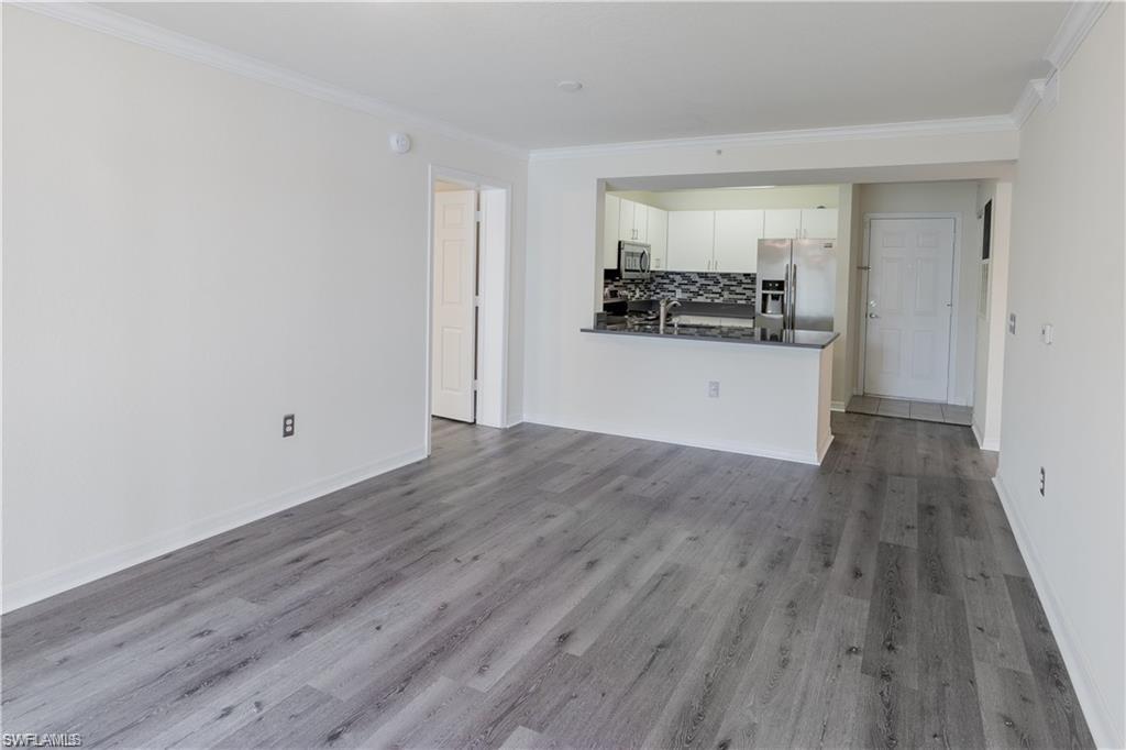 8234 Key Royal Circle, Unit 521 Naples, FL 34119 - Photo 3 of 19 a hallway with wooden floor