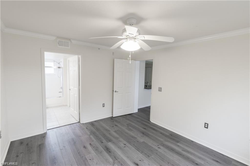 8234 Key Royal Circle, Unit 521 Naples, FL 34119 - Photo 5 of 19 a view of an empty room with wooden floor