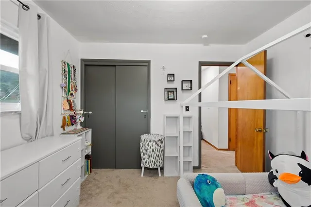 a bedroom with furniture and a window