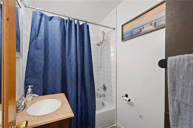 a bathroom with a shower curtain and a sink