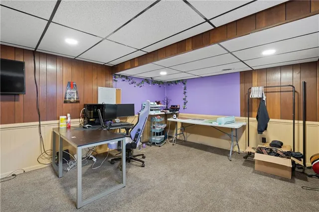 a room with gym equipment and a flat screen tv