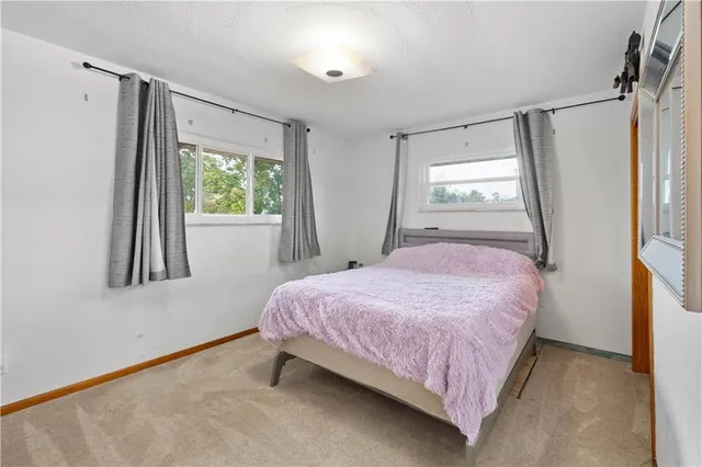 a bedroom with a bed dresser and a window